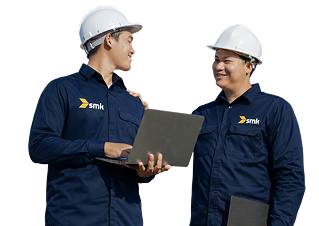 Two Men In Hard Hats Are Collaborating While Holding A Laptop